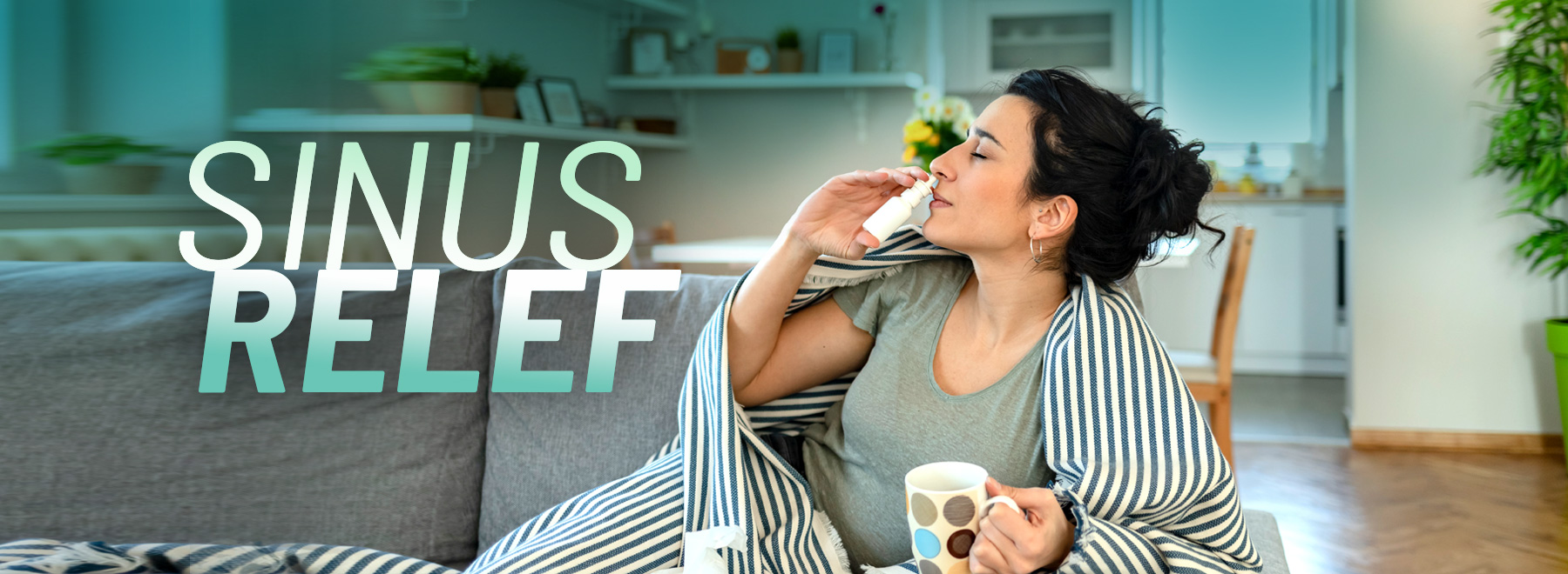 Woman on a couch with tissue and nasal spray.